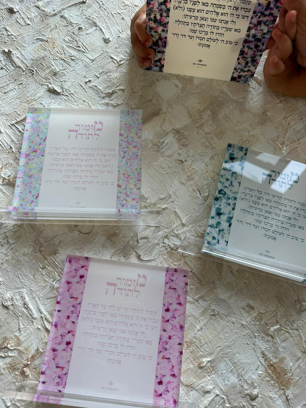Angled view of Mizmor LeToda — The Plexi Compact, psalm of gratitude artwork showing layered textures and Hebrew calligraphy by Eli Studio